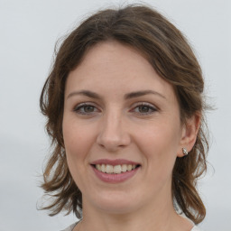 Joyful white young-adult female with medium  brown hair and green eyes