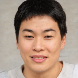 Joyful asian young-adult male with short  brown hair and brown eyes