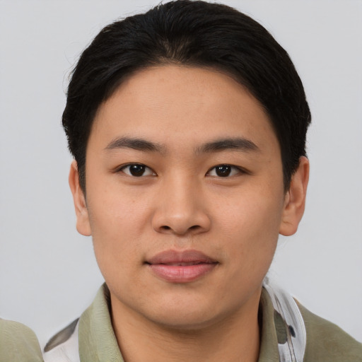 Joyful asian young-adult male with short  black hair and brown eyes