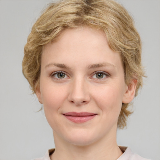 Joyful white young-adult female with medium  brown hair and green eyes