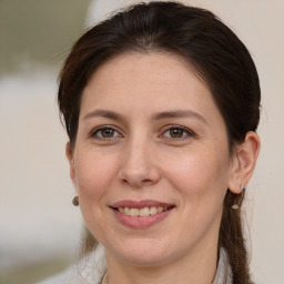 Joyful white adult female with medium  brown hair and brown eyes