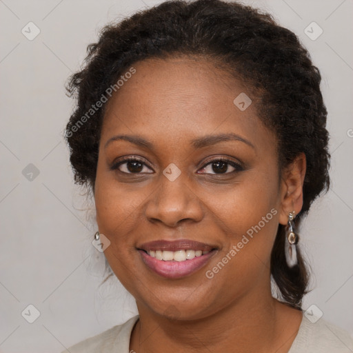 Joyful black young-adult female with long  brown hair and brown eyes