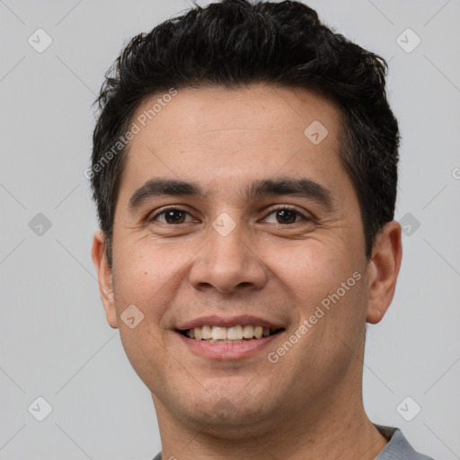 Joyful white young-adult male with short  black hair and brown eyes