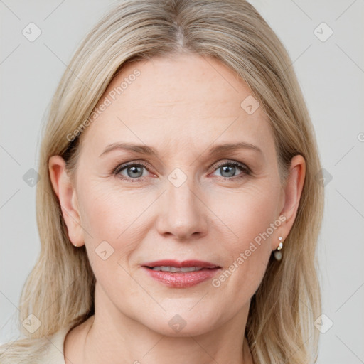 Joyful white adult female with medium  brown hair and blue eyes