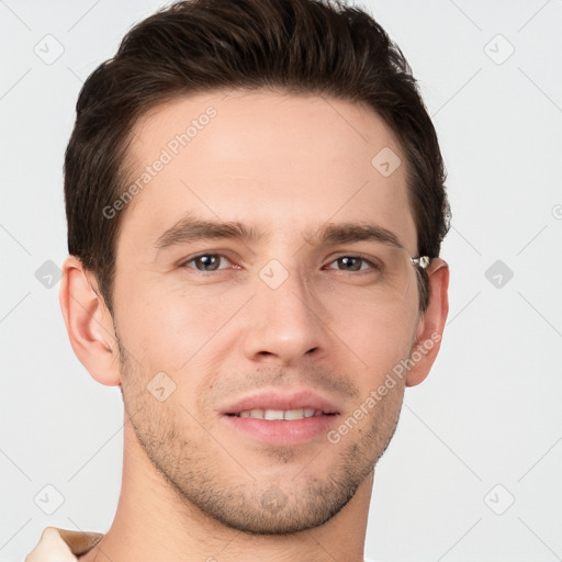 Joyful white young-adult male with short  brown hair and grey eyes