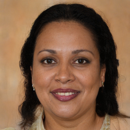 Joyful black adult female with long  brown hair and brown eyes