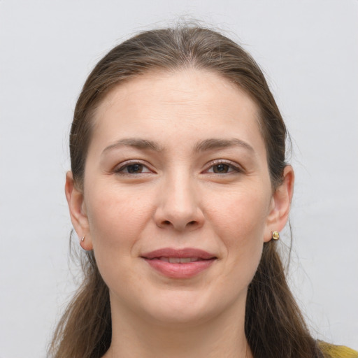 Joyful white young-adult female with long  brown hair and grey eyes