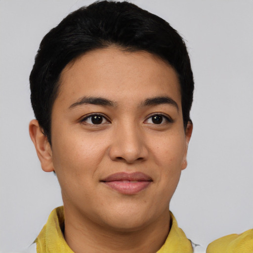 Joyful latino young-adult female with short  black hair and brown eyes