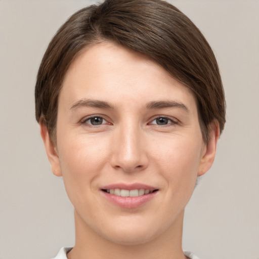 Joyful white young-adult female with short  brown hair and grey eyes