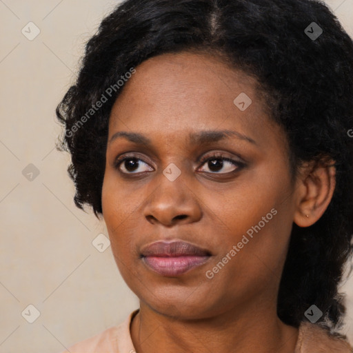 Joyful black adult female with short  black hair and brown eyes