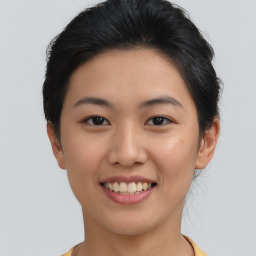 Joyful asian young-adult female with short  brown hair and brown eyes