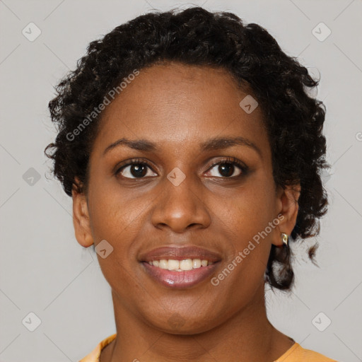 Joyful black young-adult female with short  brown hair and brown eyes