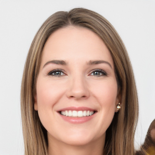 Joyful white young-adult female with long  brown hair and brown eyes