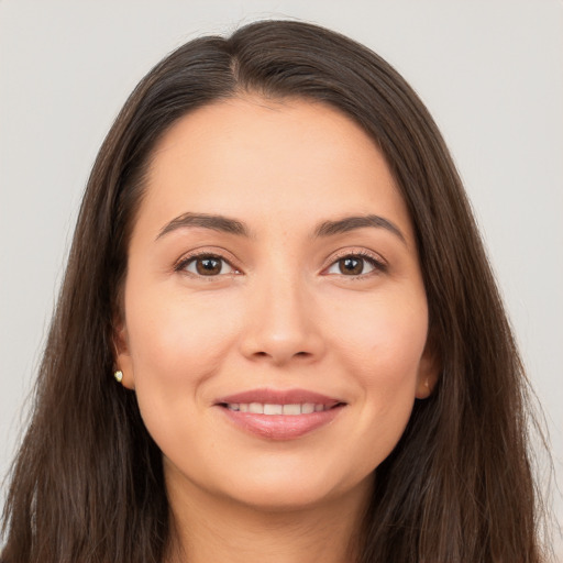 Joyful white young-adult female with long  brown hair and brown eyes