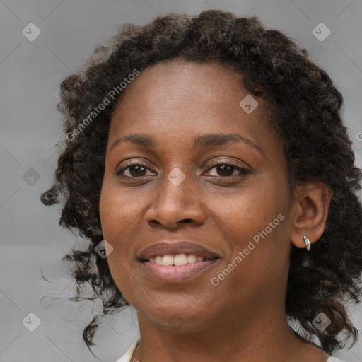 Joyful black young-adult female with medium  brown hair and brown eyes