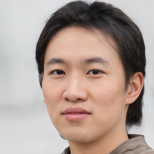 Joyful asian young-adult female with short  brown hair and brown eyes