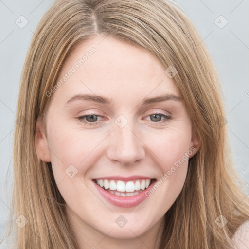 Joyful white young-adult female with long  brown hair and blue eyes