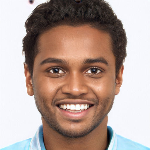 Joyful black young-adult male with short  brown hair and brown eyes