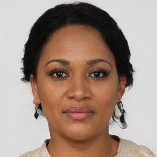 Joyful black young-adult female with medium  black hair and brown eyes