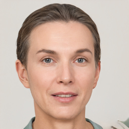 Joyful white adult female with short  brown hair and grey eyes