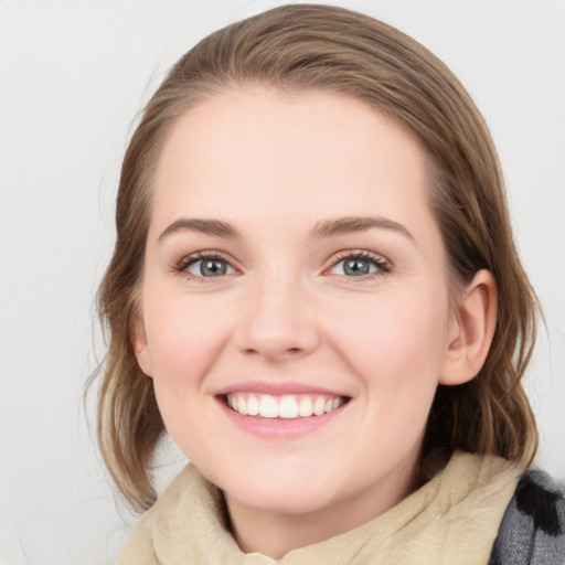 Joyful white young-adult female with medium  brown hair and blue eyes