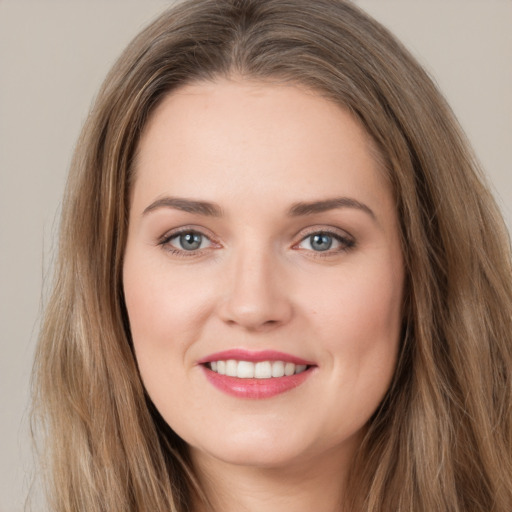 Joyful white young-adult female with long  brown hair and grey eyes