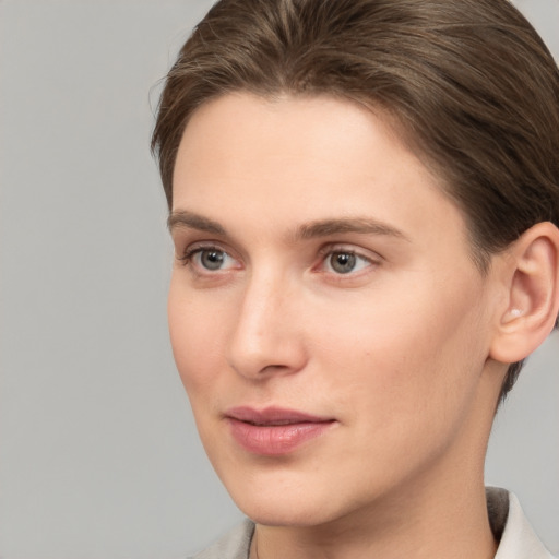 Joyful white young-adult female with short  brown hair and grey eyes