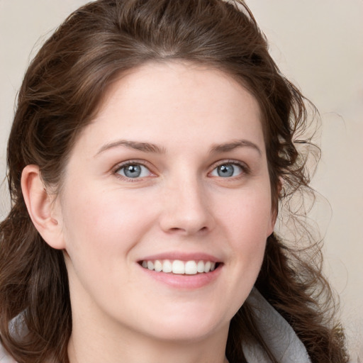 Joyful white young-adult female with medium  brown hair and blue eyes