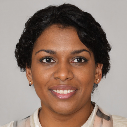 Joyful latino young-adult female with short  black hair and brown eyes