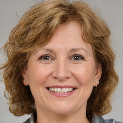 Joyful white adult female with medium  brown hair and brown eyes