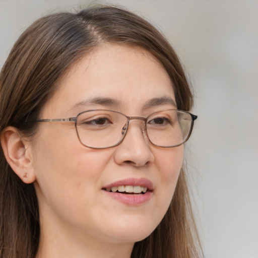 Joyful white adult female with long  brown hair and brown eyes
