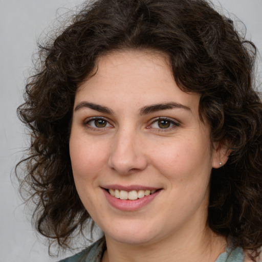 Joyful white young-adult female with medium  brown hair and green eyes