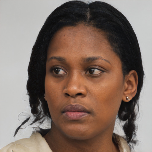 Neutral black young-adult female with medium  black hair and brown eyes
