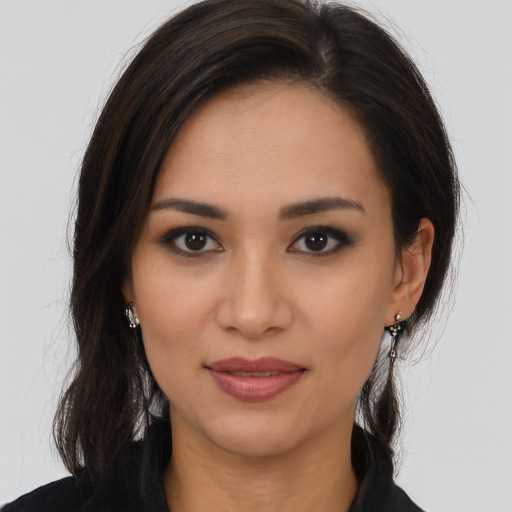 Joyful latino young-adult female with long  brown hair and brown eyes