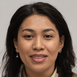 Joyful white adult female with long  brown hair and brown eyes