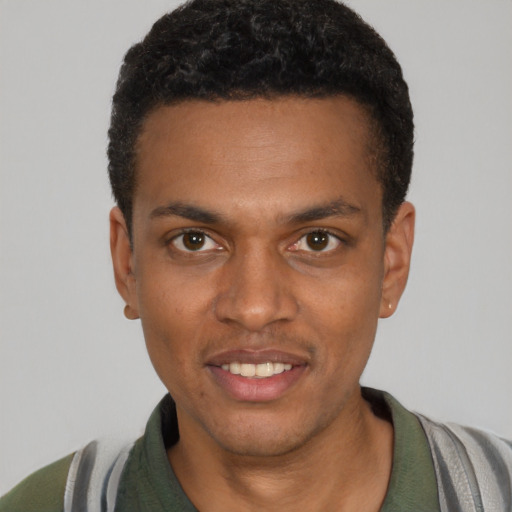 Joyful black young-adult male with short  black hair and brown eyes