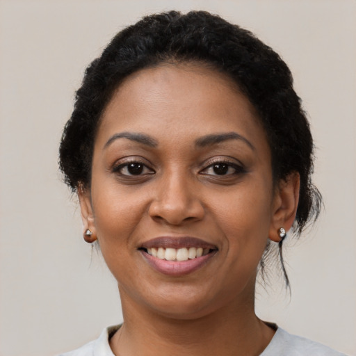Joyful latino young-adult female with short  black hair and brown eyes
