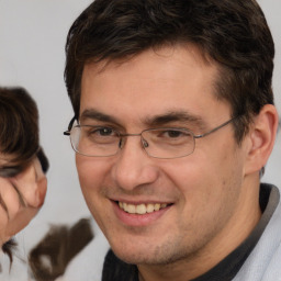 Joyful white adult male with short  brown hair and brown eyes