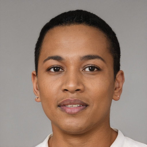 Joyful latino young-adult female with short  black hair and brown eyes