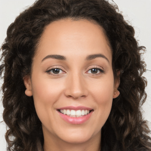 Joyful white young-adult female with long  brown hair and brown eyes