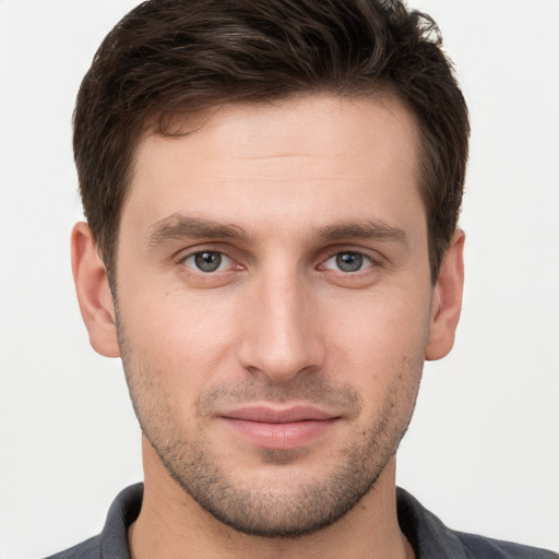 Joyful white young-adult male with short  brown hair and brown eyes