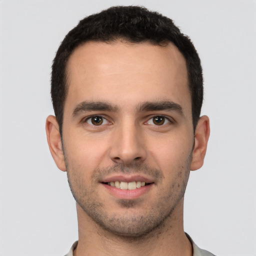 Joyful white young-adult male with short  black hair and brown eyes