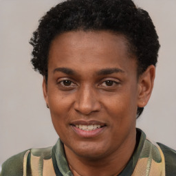 Joyful black young-adult male with short  brown hair and brown eyes