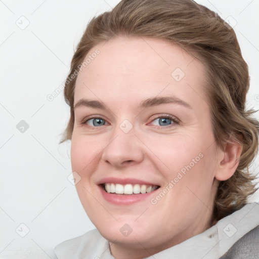 Joyful white young-adult female with medium  brown hair and blue eyes