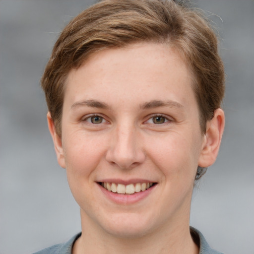 Joyful white young-adult female with short  brown hair and grey eyes