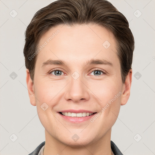 Joyful white young-adult male with short  brown hair and grey eyes