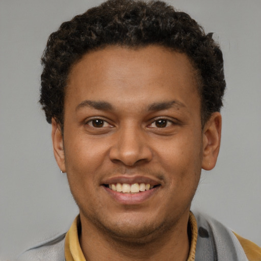 Joyful latino young-adult male with short  brown hair and brown eyes
