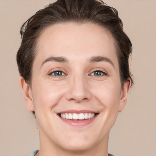 Joyful white young-adult female with short  brown hair and grey eyes