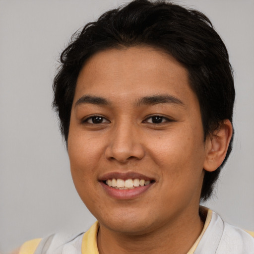 Joyful latino young-adult female with short  brown hair and brown eyes