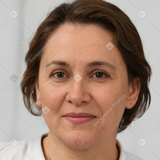 Joyful white adult female with medium  brown hair and brown eyes